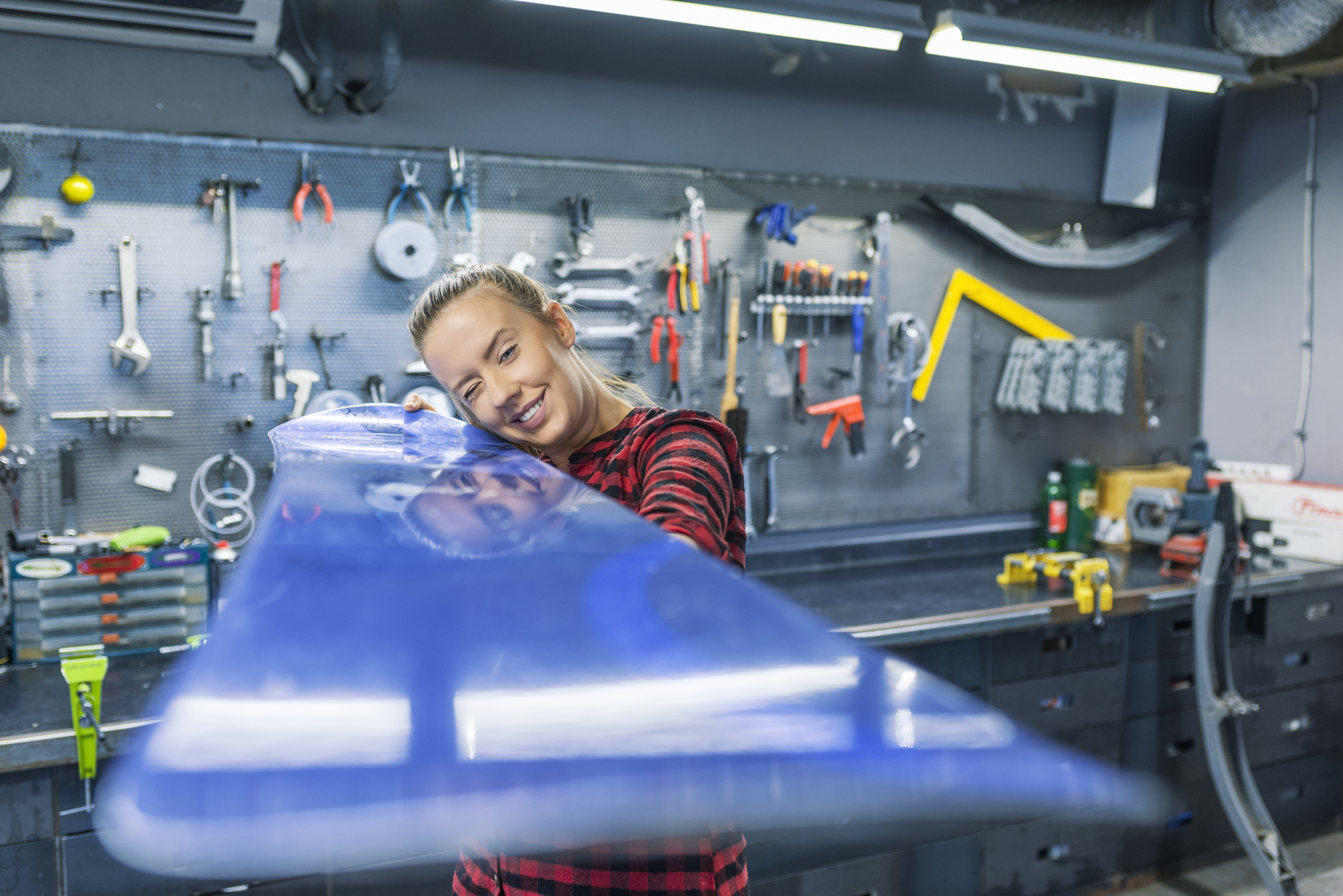 Woman working on snowboard